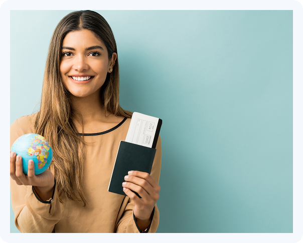 Young woman holding passport, boarding pass, and globe for international travel concept