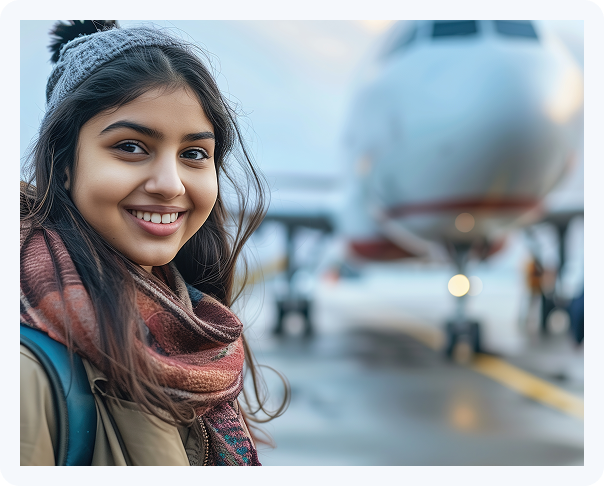 Young international traveler smiling at airport before flight departure