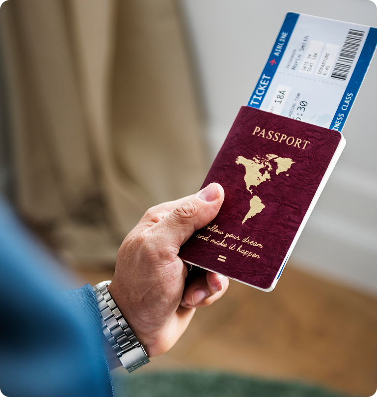 Hand holding passport and boarding pass for international travel and immigration