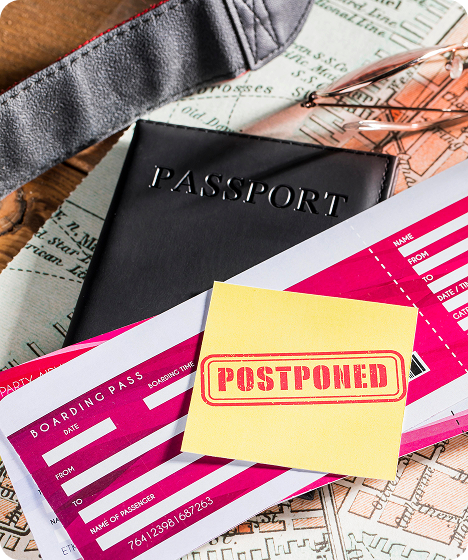 Delayed travel concept with passport, boarding pass, and postponed flight notice