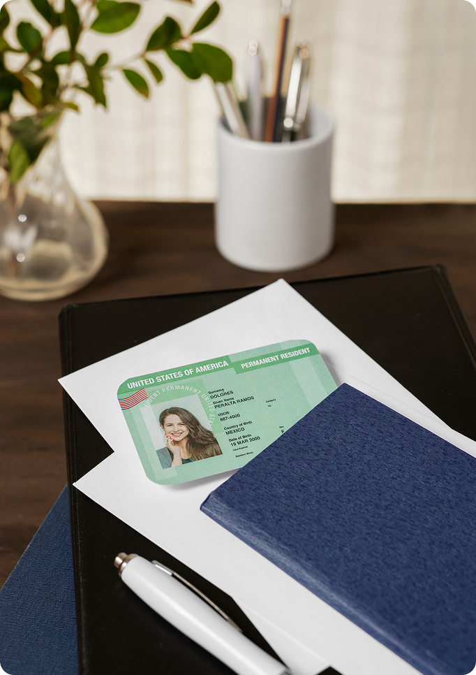 U.S. Permanent Resident Card with immigration paperwork representing Green Card applications and legal immigration services.
