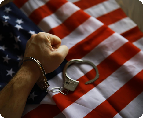 Handcuffs on the American flag symbolizing immigration detention and criminal defense