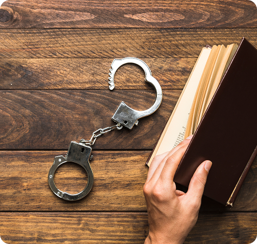 Immigration law book and handcuffs symbolizing deportation defense and legal representation