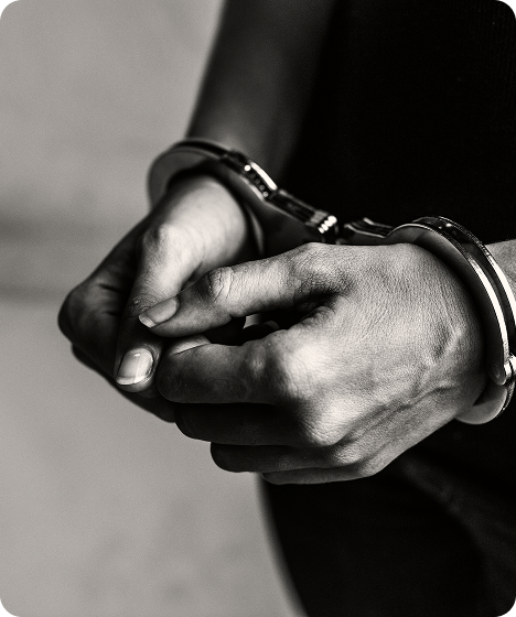 Person in handcuffs representing immigration detention, deportation defense, and legal representation by an immigration attorney.