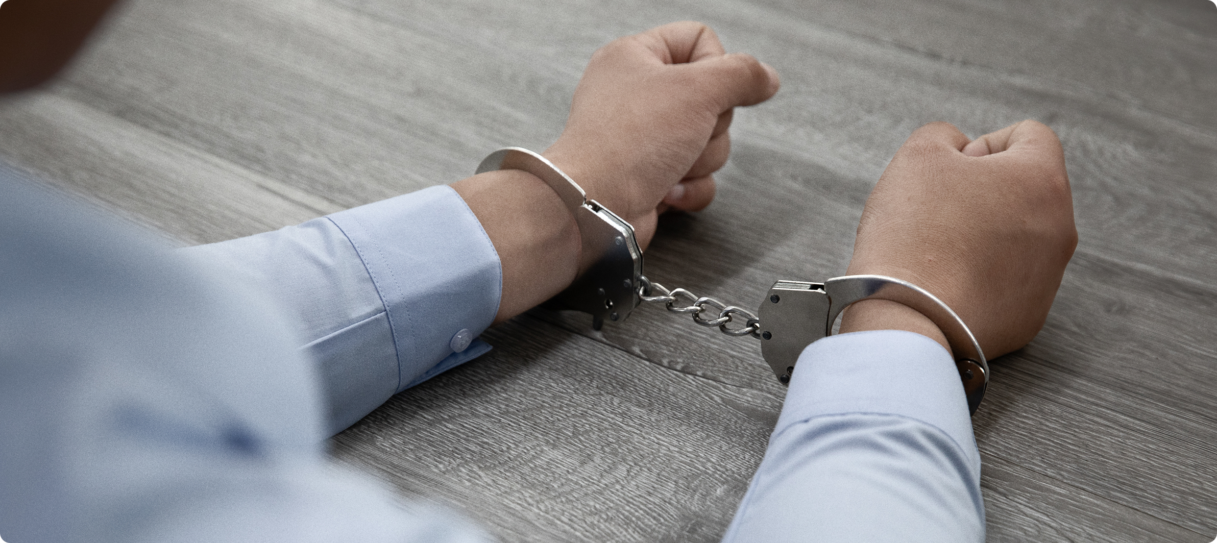 Person in handcuffs representing immigration detention, deportation defense, and legal representation for immigration cases.