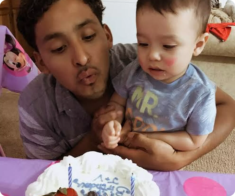 Immigrant father celebrating with his child after receiving immigration legal support and family reunification
